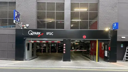 Q-Park IFSC car park entrance with barrier, height restrictor and signage.