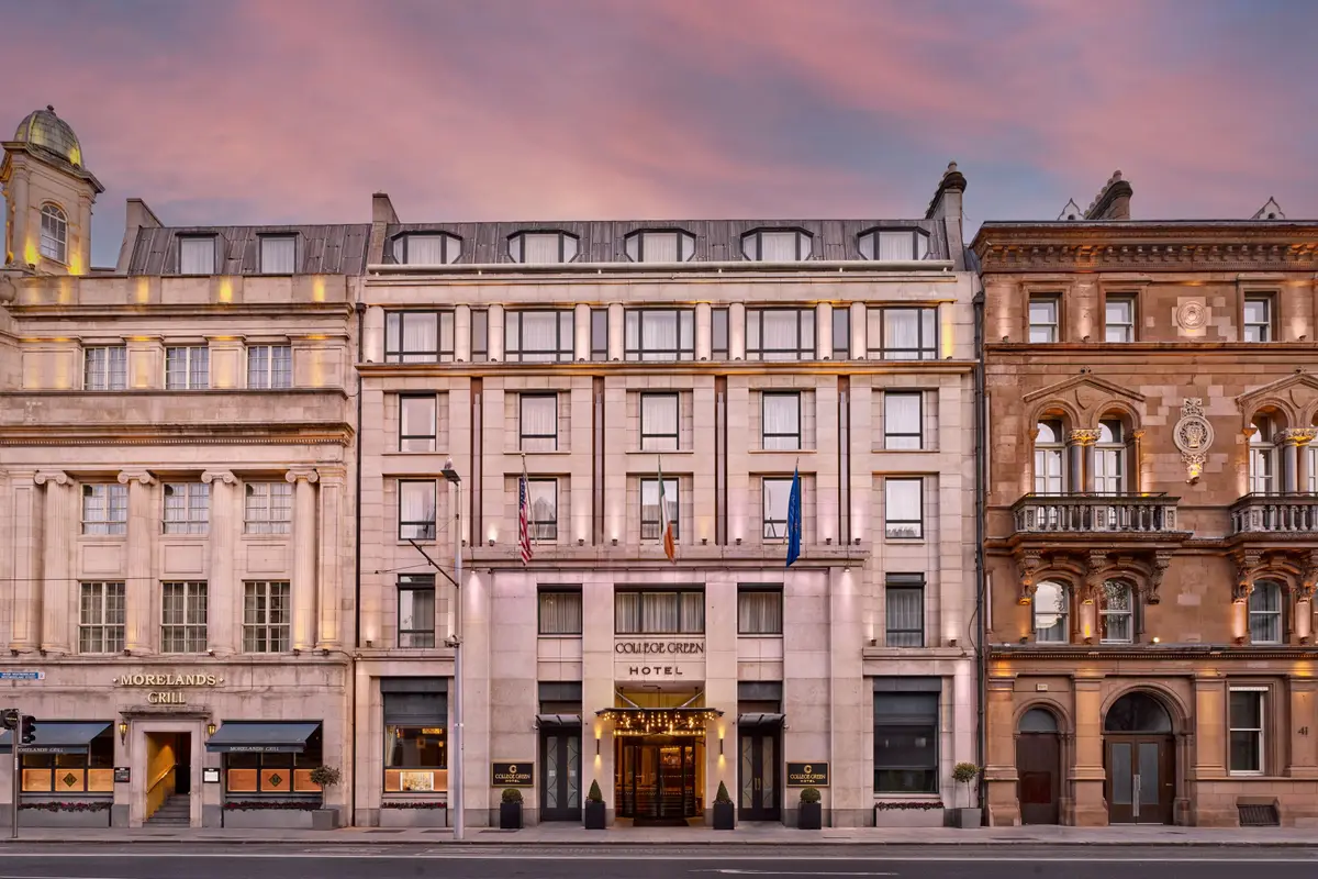 The Westin Dublin's Victorian façade on College Green at dusk.