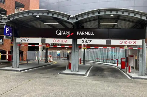 Q-Park Parnell car park entrance canopy with barriers and 24/7 signage.